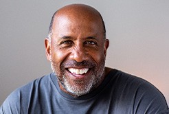Closeup of senior man in gray shirt smiling