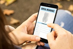 A woman filling out a dental insurance form