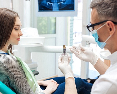 Dentist explaining differences between various dental implant treatments