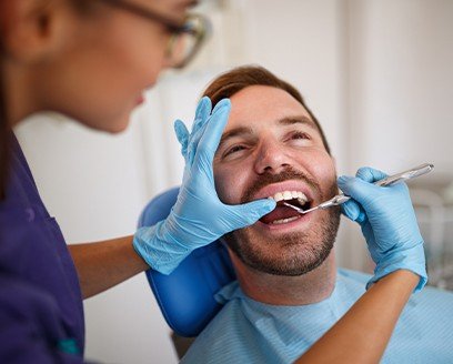 Man receiving tooth-colored filling treatment