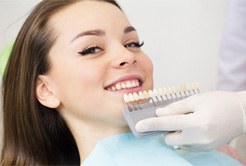 Woman receiving dental veneers from cosmetic dentist