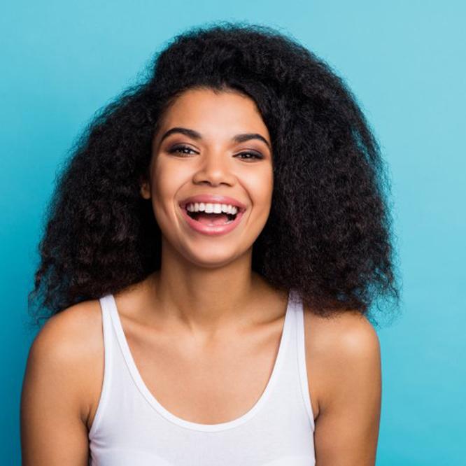 Woman smiling with dental crowns in Fort Worth