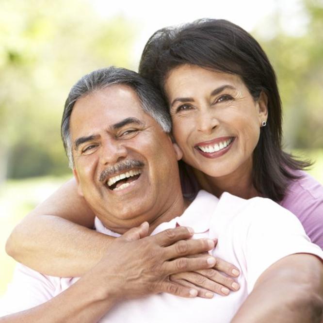 Smiling older man and woman with dentures in Fort Worth