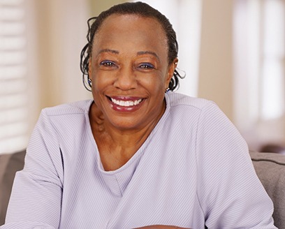 Woman smiling while sitting in armchair