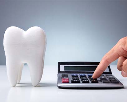 Calculator next to tooth, figuring cost of dental care