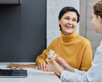 Dental patient speaking with a dental hygienist