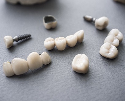 Multiple dental implants crowns and bridges on table