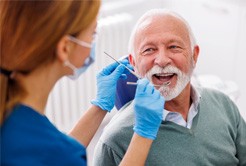 Mature man smiling during dental checkup