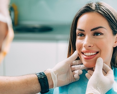 Dentist examining woman's smile