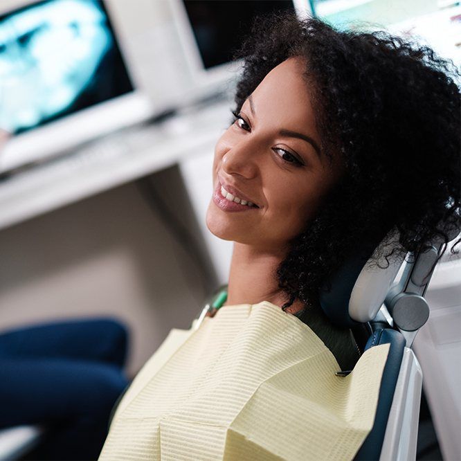 Woman in dental chair smiling