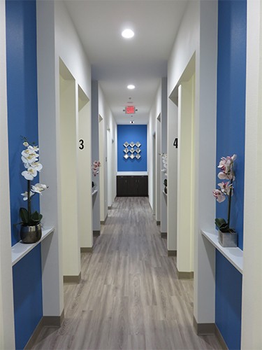 Hallway branching off into several dental treatment rooms