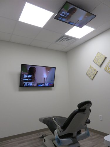 T V screen on wall of dental treatment room