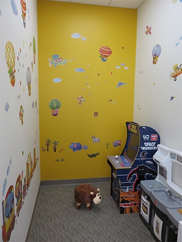 Kids play area with arcade game in dental office