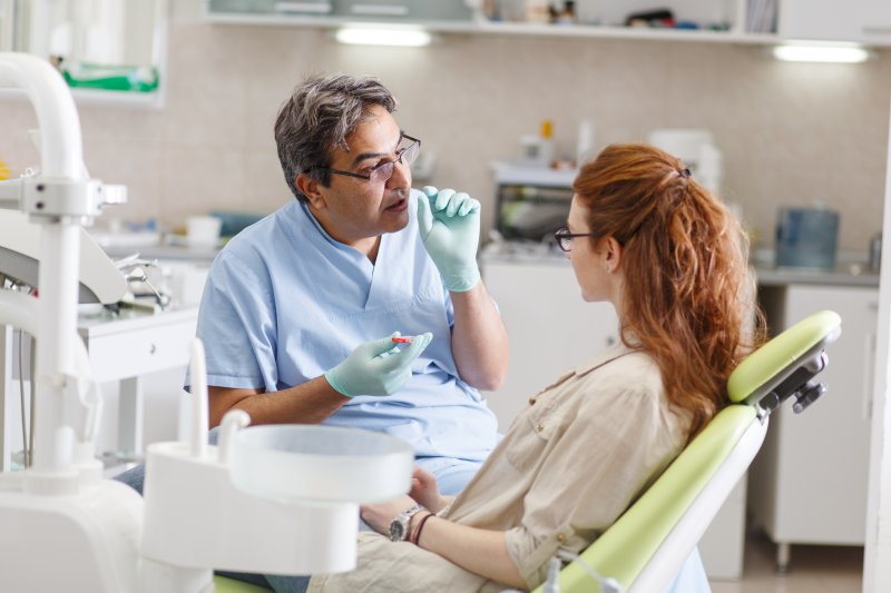 Dentist talking to patient about dental implant procedure