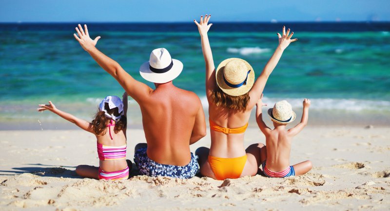 family on beach during summer vacation