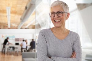 senior woman smiling after a full-mouth reconstruction