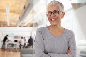 senior woman smiling after a full-mouth reconstruction 