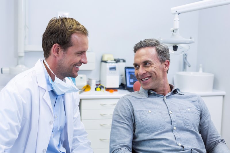 dentist talking to patient about oral bacteria