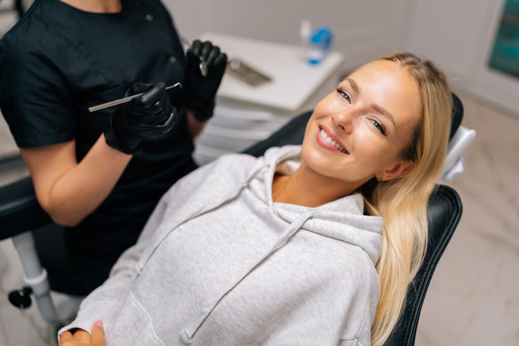 Patient reclined in treatment chair smiling