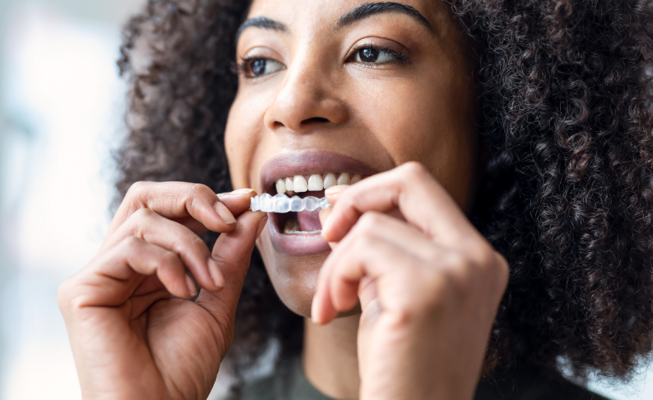 Woman putting on Invisalign